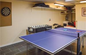 a ping pong table in a room with a ping pong court at Four-Bedroom Holiday Home In Storvorde in Storvorde