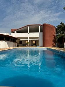 a large swimming pool in front of a building at Kayzen house in Ngaparou