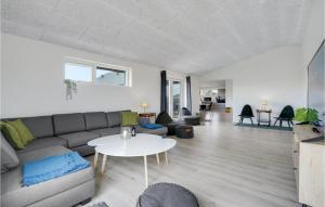 a living room with a couch and a table at Lovely Home In Thisted With Sauna in Thisted