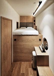 a bedroom with a bed and a desk with a bed istg at Althia Capsule Quarters in Badung