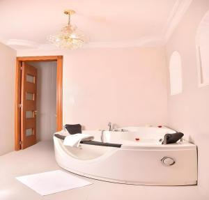 a white bathroom with a white tub in a room at Hotel Boutique Casa Ruth en Cuenca in Cuenca +72 photos