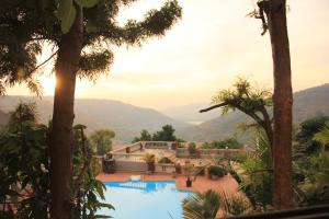 a resort with a view of a pool and mountains at Mount View Executive in Panchgani