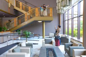 two people standing on a staircase in a building at Ooedo Onsen Monogatari Premium Hotel Sokan in Matsushima