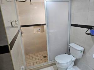 ein kleines Badezimmer mit Toilette und Dusche in der Unterkunft Hermoso Apartamento 2 recámaras L4 in Puerto Vallarta + 21 Fotos