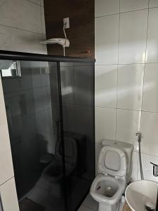 a small bathroom with a toilet and a sink at Casa Almeida in Tiradentes +12 photos