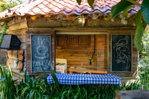 a small building with a sign on the side of it at Las Cabañitas de El Escondite in San Salvador