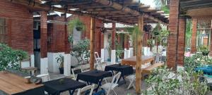 a patio with tables and chairs and a brick building at Pousada O Encontro - Frente ao Mar - Rio de Janeiro, Praia do Recreio in Rio de Janeiro +48 photos