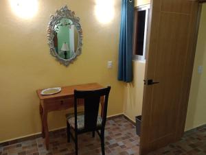 a dining room table with a chair and a mirror at Manzanillo BNB in Manzanillo +24 photos