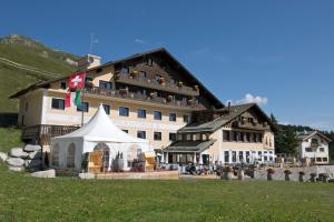 a large building with a white tent in front of it at Hotel Salastrains in St. Moritz