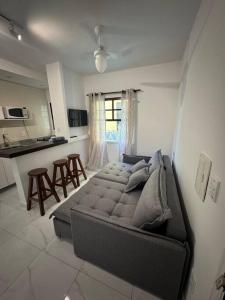 a bedroom with a bed in the middle of a room at Apartamento Jardim Geribá in Búzios