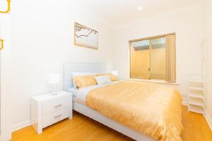 biała sypialnia z łóżkiem i oknem w obiekcie Glenelg House Modern 5QBed,1cot,3Bth, 4TV, Pet w mieście Glenelg
