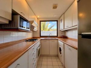a large kitchen with a sink and a window at Modern San Alfonso del Mar - BBQ Parking Pool Wifi in Algarrobo +14 photos