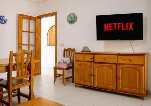 a living room with a television on a wall at Euromar II - TEPINSA Alquiler de Apartamentos in Torreblanca