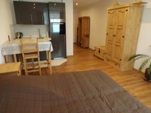eine Küche mit einem Tisch und eine Küche mit einem Kühlschrank in der Unterkunft Ferienwohnung Gittersee in Dresden