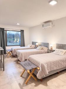 a room with three beds and a window at Casas de Viña in Villa Unión +107 photos