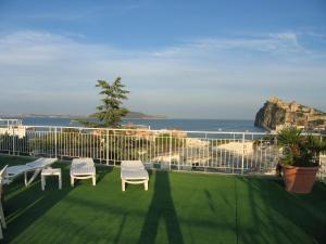 a balcony with chairs and a view of the ocean at Hotel Europa in Ischia