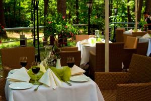 a couple of tables with wine glasses and napkins at Hotel Mościcki in Spała