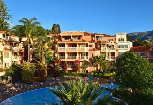 a view of a hotel with a swimming pool and a resort at Pestana Miramar Garden & Ocean Hotel in Funchal