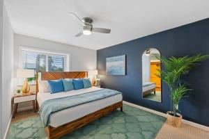 a bedroom with a large bed with blue walls at 4 BR Home with Game Room! Family Friendly! Centrally Located! in San Diego