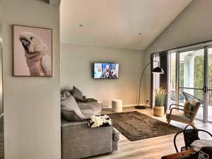 a living room with a couch and a large window at Team Luxury Home for Short or Long Stays in Muswellbrook