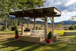 a table and chairs under a pavilion in a field at Milford Country Cottages in Milford