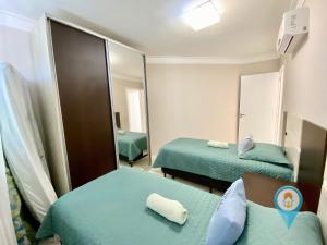 N6802 Cobertura Vista Mar Praia e Beto Carrero في بنها: غرفة فندقية بسريرين ومرآة +116 صورة