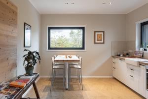 a kitchen with a table and chairs and a window at Casa Vertigo in Trento