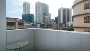 a view of a city skyline from a balcony at RedDoorz at TJMG by Bel Air Polaris Makati in Manila