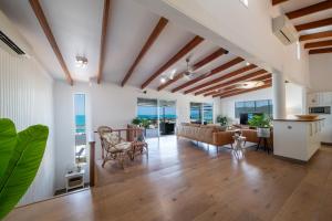 a living room with a couch and a table at Nautilus On The Hill - Airlie Beach in Airlie Beach +23 photos