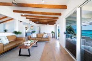 a living room with a couch and a table at Nautilus On The Hill - Airlie Beach in Airlie Beach +23 photos