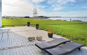 a patio with a bench and a table and some plants at Apartment Nordre Strandvej Ebeltoft I in Ebeltoft