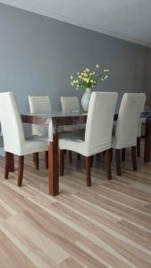 a dining room table with white chairs and a vase at Whole House Fair Price Great Amenities in Richmond Hill