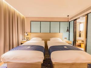 Letto o letti in una camera di Echarm Hotel Putian Chengxiang Wenxing Pedestrian Street Branch