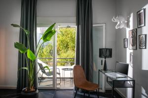 a living room with a glass table and a plant at Icos City 2 in Hersonissos