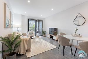 a living room with a couch and a table at Aircabin - Epping - Modern Comfy - 1 Bed Apt in Epping
