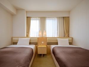 Postel nebo postele na pokoji v ubytování The OneFive Tokyo Kameido