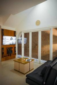 a living room with a couch and a table at Bylina House in Batu +27 photos