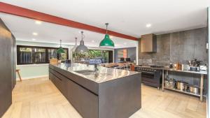a kitchen with a large island in the middle at Aunty Olive's - Pearl Beach in Pearl Beach