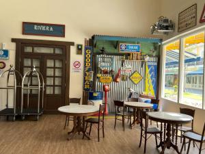 a dining room with tables and chairs in a restaurant at JOM at deRiviera Self check-in in Malacca