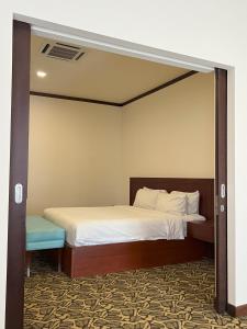 a bedroom with a bed with a large mirror at JOM at deRiviera Self check-in in Melaka