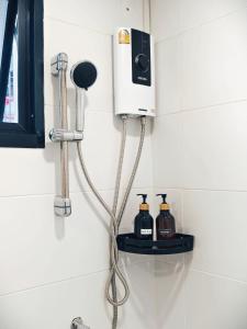 a bathroom with a blow dryer on a wall at Fivehouse Silom2 soi11 City heart Silom BTS 7min in Bang Rak