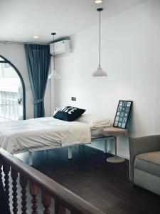 a bed in a room with a couch and a chair at Fivehouse Silom2 soi11 City heart Silom BTS 7min in Bang Rak +79 photos