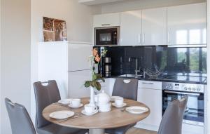 a kitchen with a wooden table with chairs and a dining room at Prince in Binz