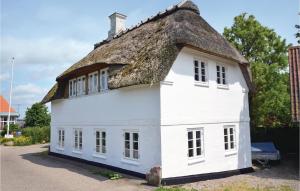 a white house with a thatched roof at Two-Bedroom Holiday Home In Grasten in Gråsten
