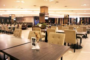 a dining room with tables and chairs in a restaurant at Grand Serpong Hotel in Panunggangah +22 photos