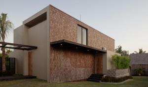 a brick house with a window on it at Usawa Villa Nyanyi in Munggu