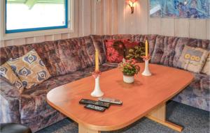 a living room with a couch and a wooden table at Holiday Home Blomstervangen Denmk Iv in Oksbøl