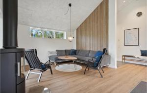 a living room with a couch and a table and chairs at Awesome Home In Tarm With Kitchen in Tarm