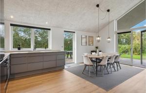 a kitchen and dining room with a table and chairs at Awesome Home In Tarm With Kitchen in Tarm