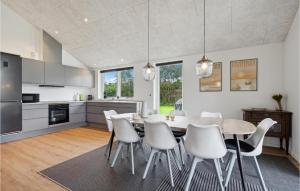 a kitchen and dining room with a table and chairs at Awesome Home In Tarm With Kitchen in Tarm